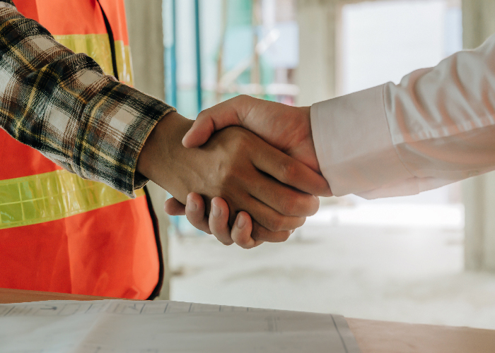 construction worker team contractor hand shake after finishing up a business meeting to greeting start up project contract in construction site building, teamwork, partnership and industry concept